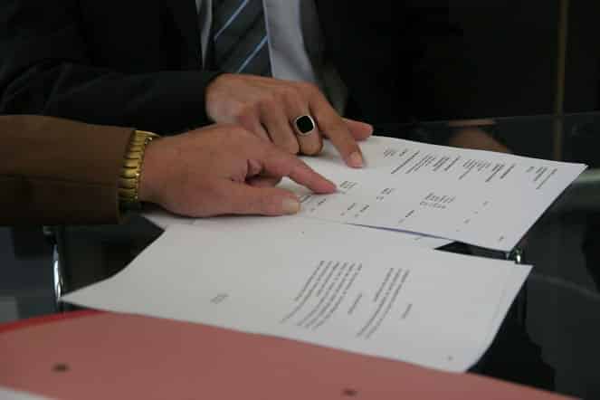 businessman reading contract papers closeup